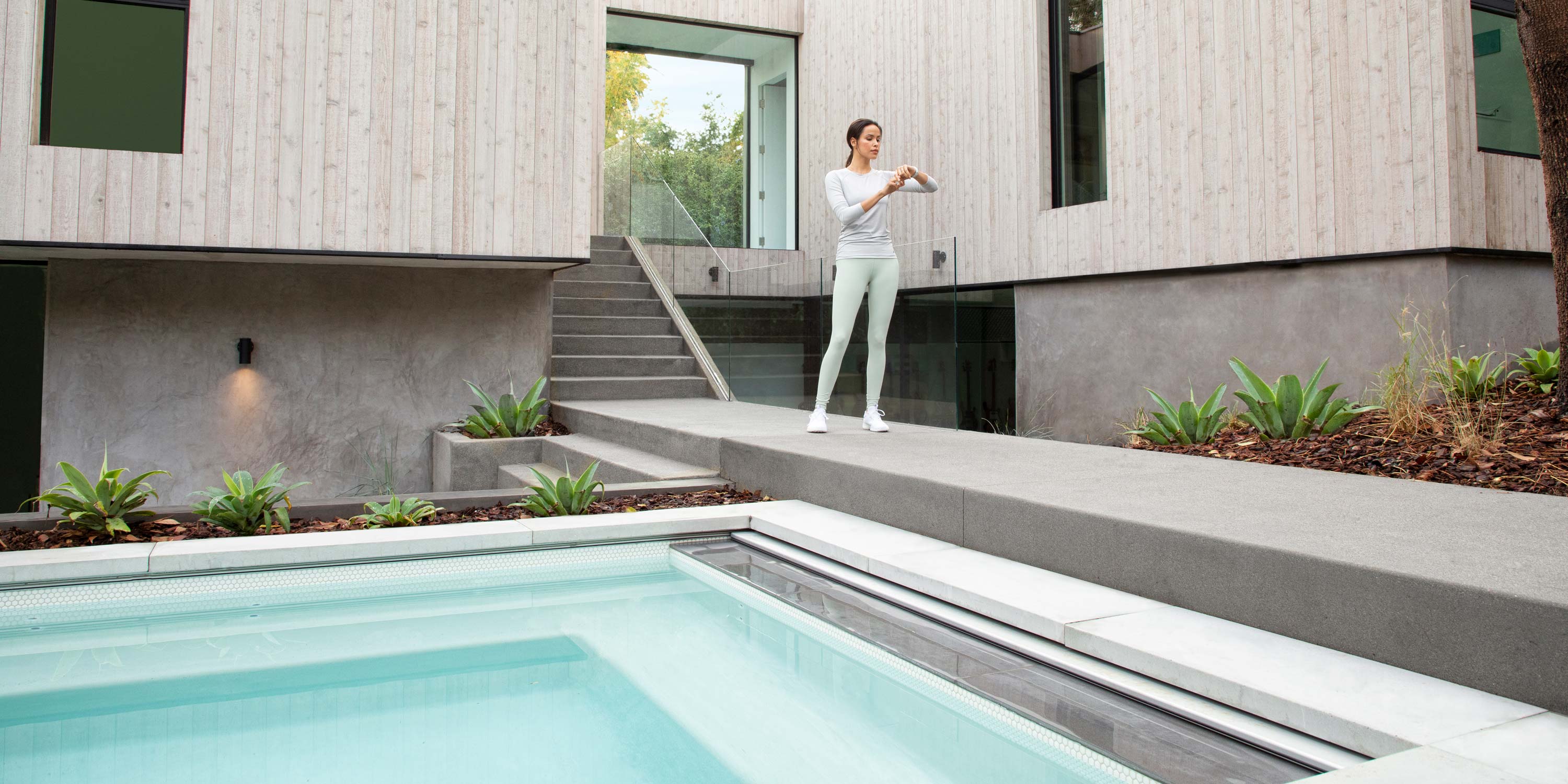 woman standing outside by pool