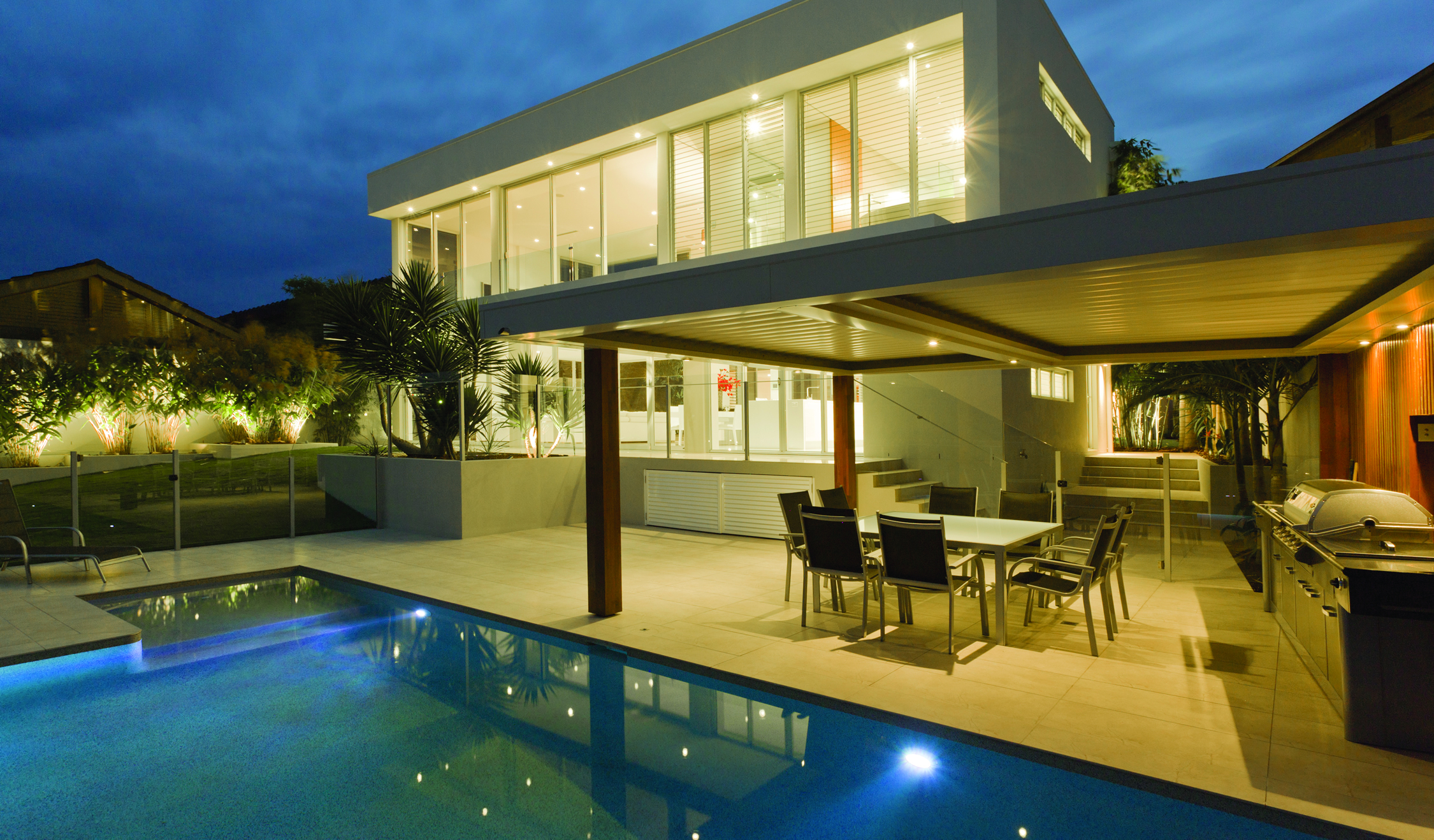 yellow-toned home with outdoor kitchen and pool